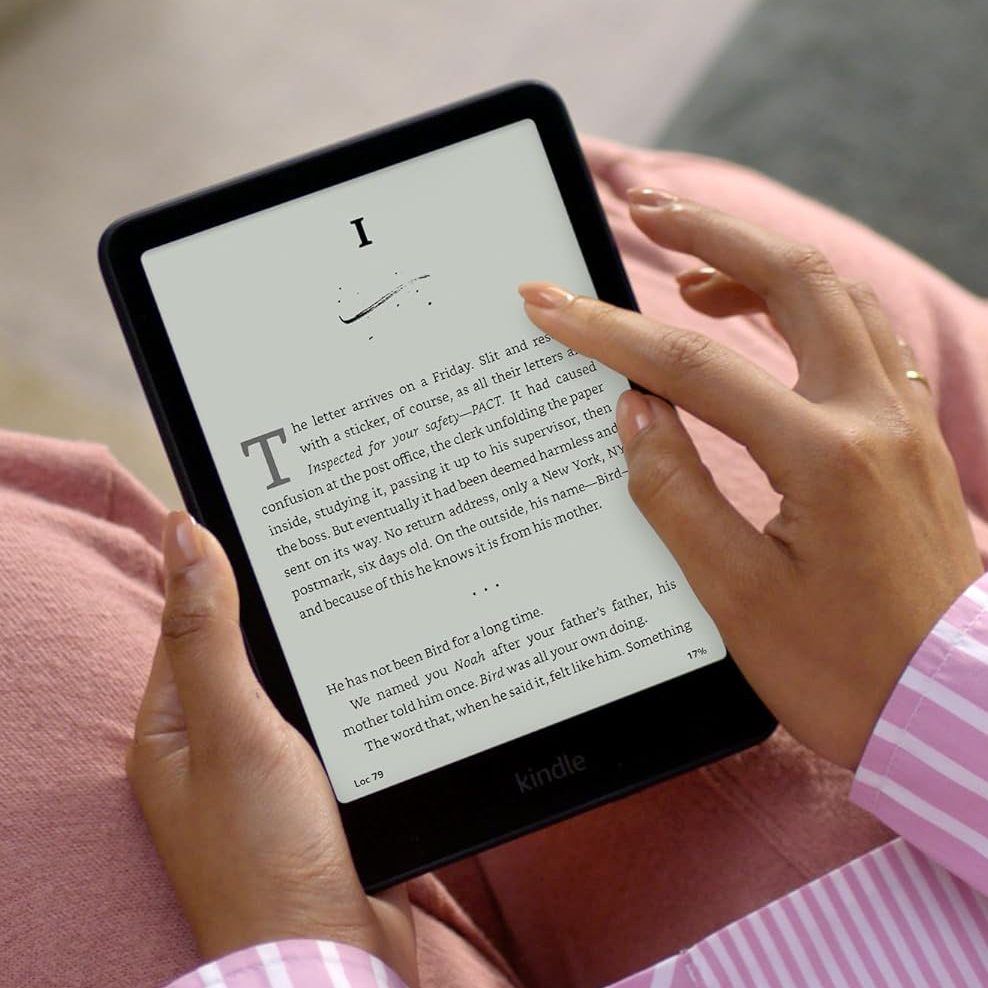 Two hands holding a Kindle.